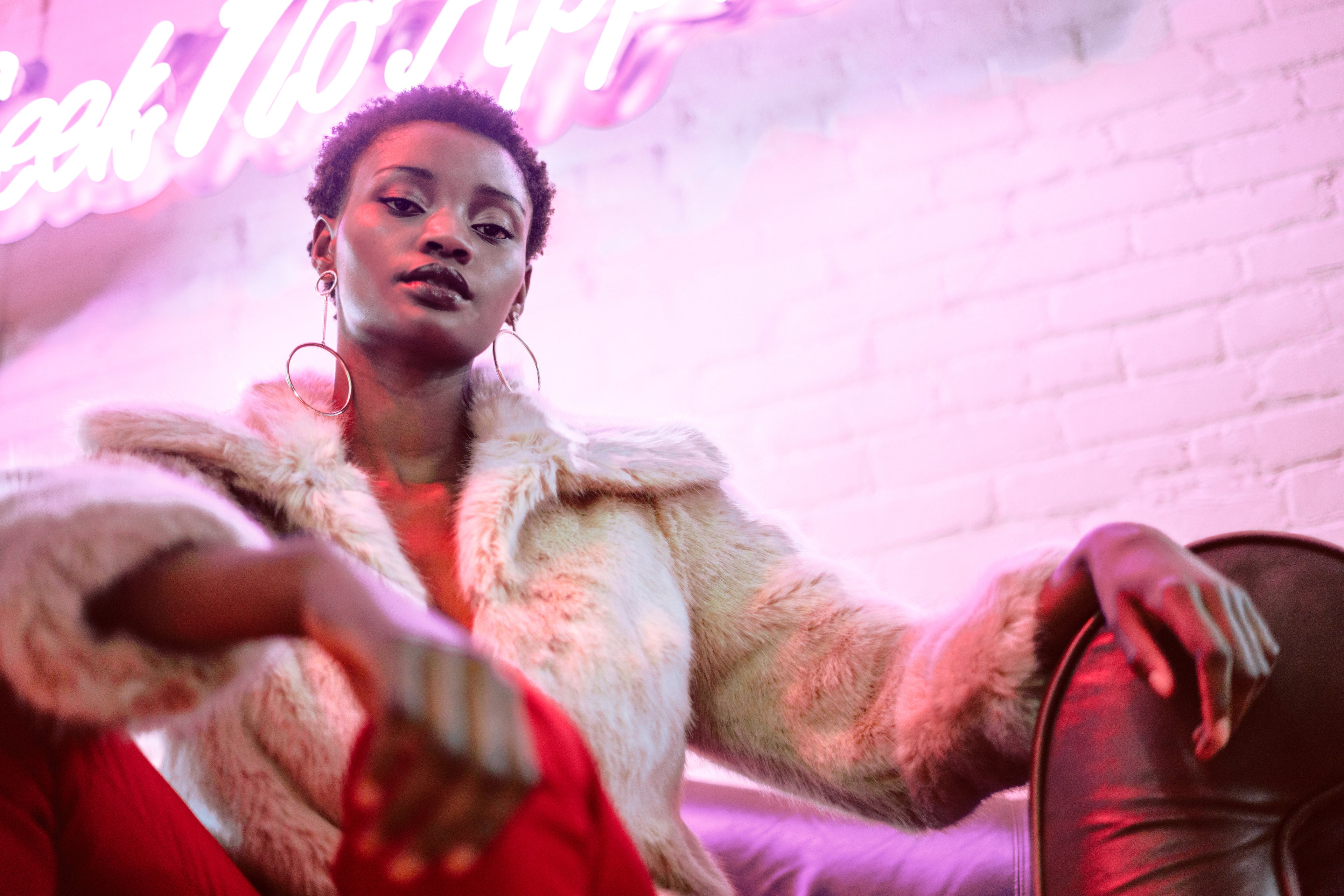 Woman with radiant, healthy skin, highlighting natural care under neon lights.